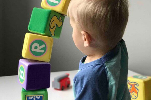 Boy playing with toy blocks, Toys are more than just toys, Be Curious
